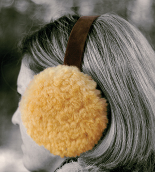 Lambswool earmuffs on a woman's head from the Wool Shop Comfort Collection
